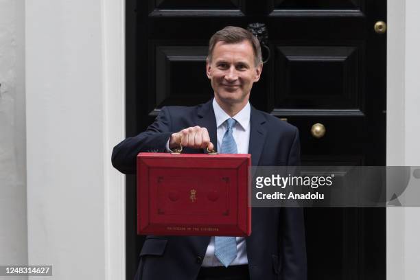 Britain's Chancellor of the Exchequer Jeremy Hunt holds the Budget box outside 11 Downing Street ahead of the announcement of the Spring Budget in...