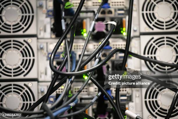 March 2023, Rhineland-Palatinate, Mainz: Cabling for data and cooling of the high-performance computer are seen during the inauguration ceremony of...