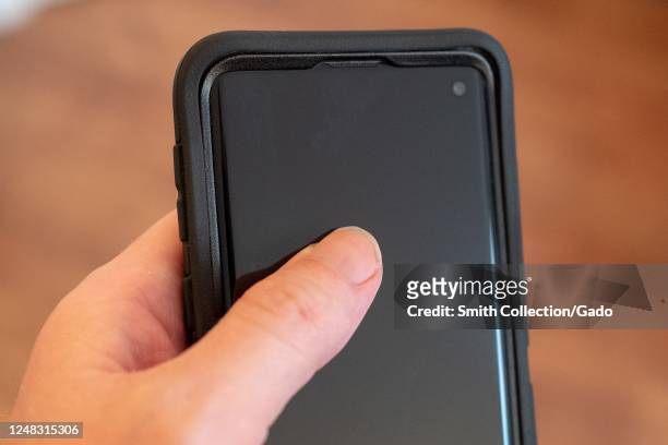 Hand of a man holding a Samsung Galaxy S10 smart phone, San Ramon, California, June 5, 2020.