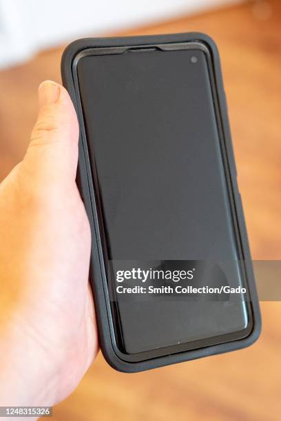 Hand of a man holding a Samsung Galaxy S10 smart phone, San Ramon, California, June 5, 2020.