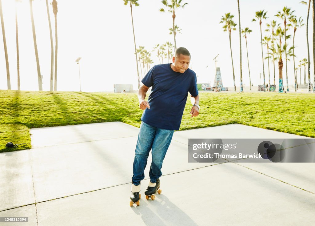 Mature man roller skating in park