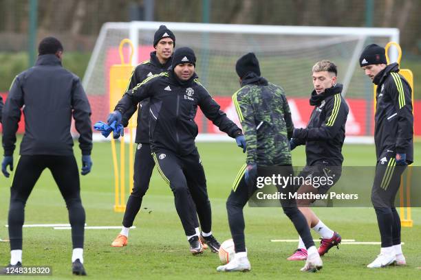 Casemiro & Lisandro Martinez of Manchester United in action with team-mates during a Manchester United first team training session at Carrington...