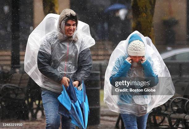 Boston, MA Heavy rain and strong winds batter pedestrians during a Noreaster.