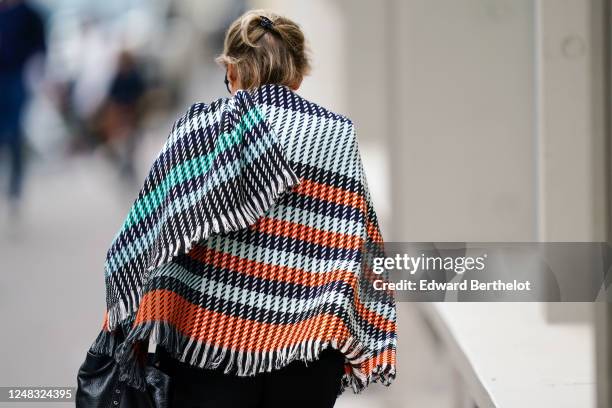 Passerby wears a fringed and striped plaid with printed geometric patterns, on June 08, 2020 in Paris, France.