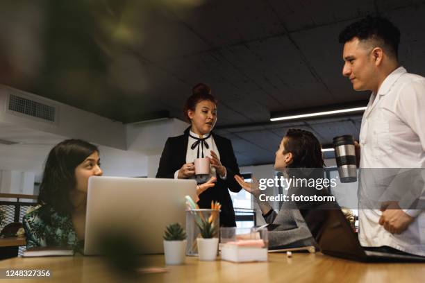 coffee time to discuss meeting decisions - hub stock pictures, royalty-free photos & images