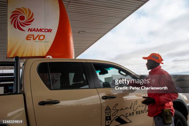 Petrol station attendant takes payment from a customer at a NAMCOR petrol station on the outskirts of Swakopmund. The National Petroleum Corporation...