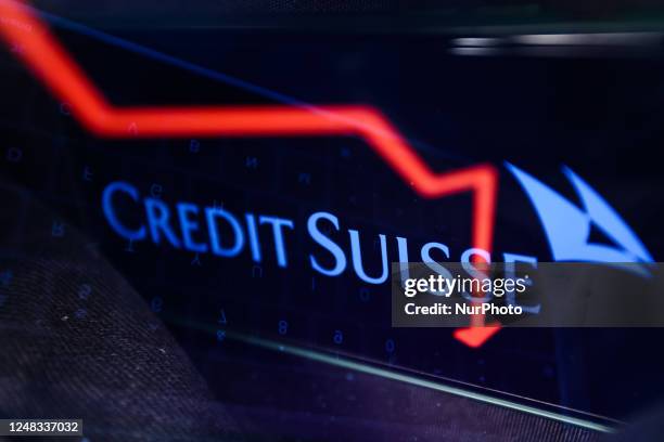 An illustrative stock chart displayed on a laptop screen and Credit Suisse logo displayed on a phone screen are seen in this multiple exposure...