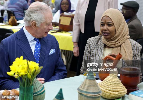 Britain's King Charles III talks with Darfur genocide survivor Amouna, during a visit to meet with members of the Sudanese community from across the...