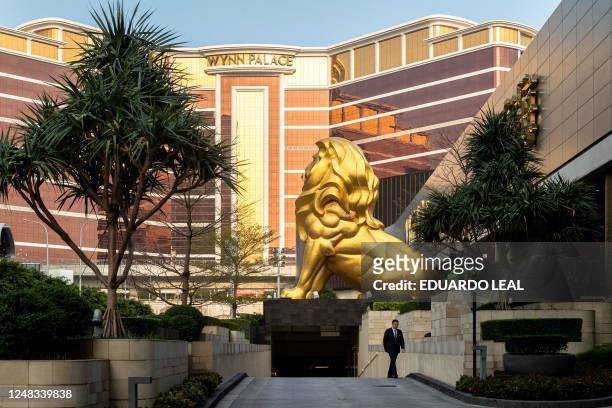 Man walks in front of the Cotai's MGM hotel resort in Macau on March 15, 2023.