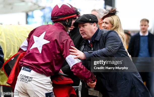 Gloucestershire , United Kingdom - 15 March 2023; Jockey Keith Donoghue is congratulated by trainer Gordon Elliott after winning the Glenfarclas...