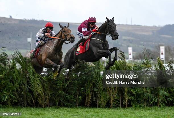 Gloucestershire , United Kingdom - 15 March 2023; Delta Work, with Keith Donoghue up, jumps the last ahead of second placed Galvin, with Davy Russell...