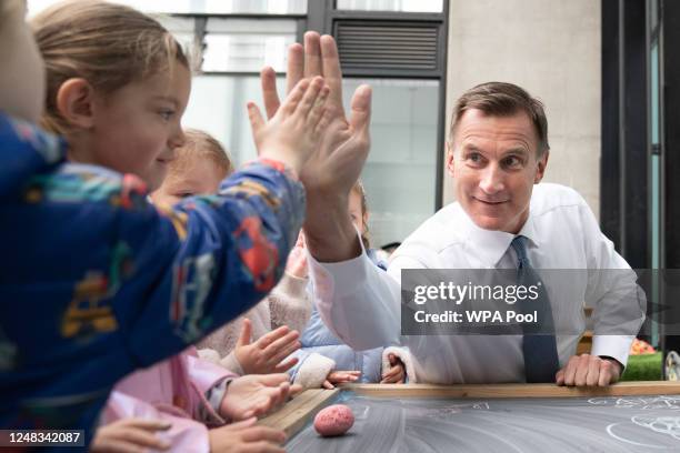 Chancellor of the Exchequer, Jeremy Hunt meets children during a visit to Busy Bees Battersea Nursery in south London, after delivering his Budget...