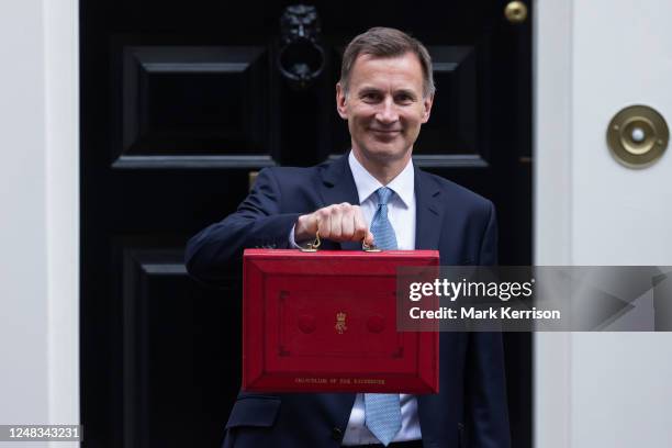 Jeremy Hunt, UK Chancellor of the Exchequer, leaves 11 Downing Street with the budget despatch box to present his Budget speech in the House of...