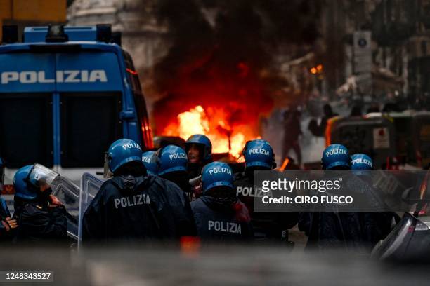 This photo obtained from Italian news agency Ansa shows Eintracht Frankfurt fans clash with anti-riot police on March 15, 2023 in downtown Naples...