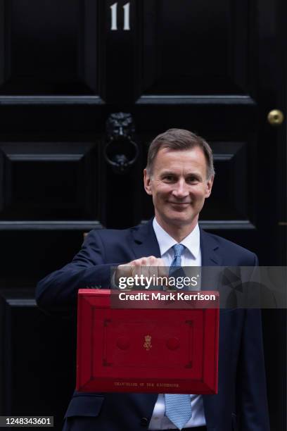 Jeremy Hunt, UK Chancellor of the Exchequer, leaves 11 Downing Street with the budget despatch box to present his Budget speech in the House of...