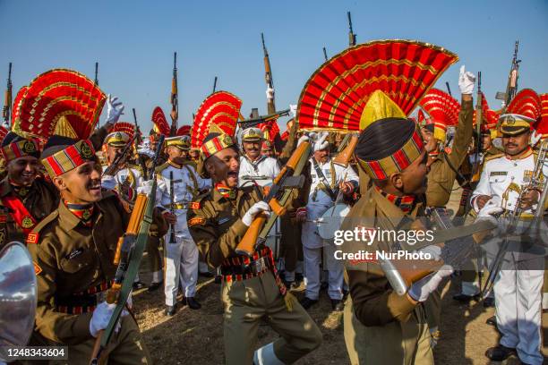 Indian Border Security Force soldiers dance and celebrate before their passing out parade at a garrison on March 15, 2023 in Humahama on the...