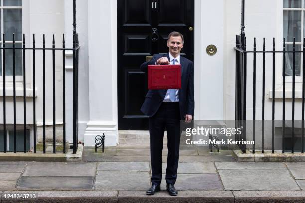 Jeremy Hunt, UK Chancellor of the Exchequer, leaves 11 Downing Street with the budget despatch box to present his Budget speech in the House of...
