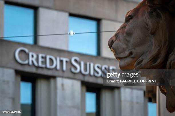 Sign of Credit Suisse bank is seen on a branch building in Geneva, on March 15, 2023. - Credit Suisse shares nosedived on March 15 after its main...