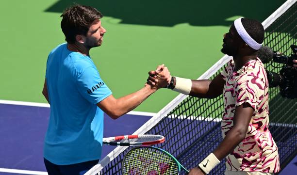 S Frances Tiafoe shakes hands with Britain's Cameron Norrie at the net after Tiafoe's victory in their quarterfinal tennis match at the 2023 ATP...