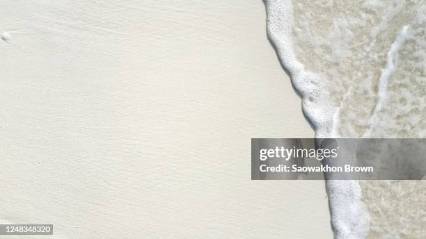 close up of waves crashing on sand, beach holiday. copy space - white sand stock pictures, royalty-free photos & images