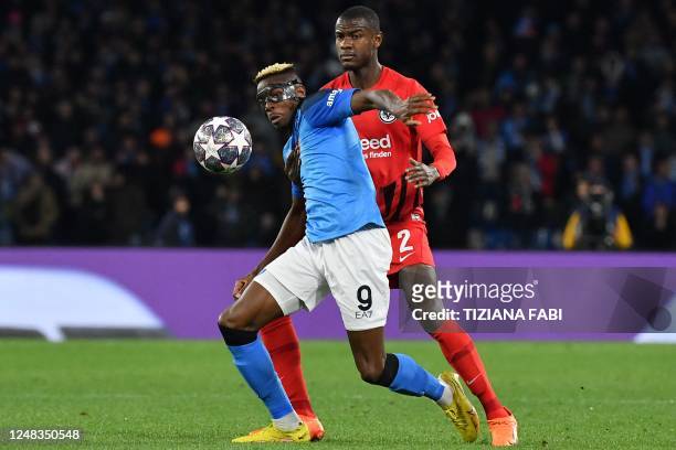 Napoli's Nigerian forward Victor Osimhen and Frankfurt's French defender Evan N'Dicka go for the ball during the UEFA Champions League round of 16,...