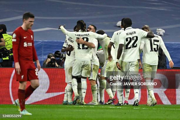 Real Madrid's players celebrate their goal scored by French forward Karim Benzema during the UEFA Champions League last 16 second leg football match...