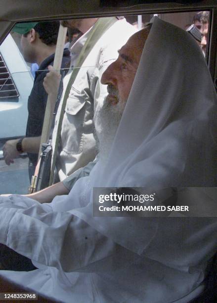 The spiritual guide of the radical Palestinian Islamic group Hamas, Sheikh Ahmed Yassin, is seen in the front passenger seat of a jeep during a...