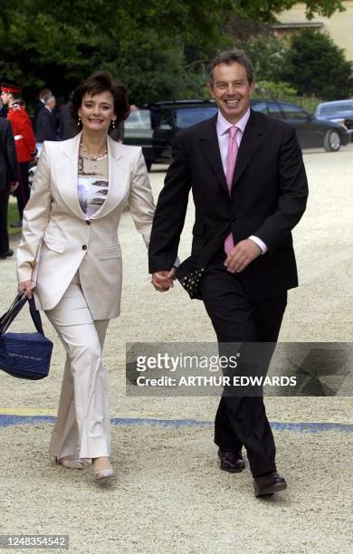 British Prime Minister Tony Blair and his wife, Cherie, arrive in the gardens of Buckingham Palace Monday June 3 for the second concert to...