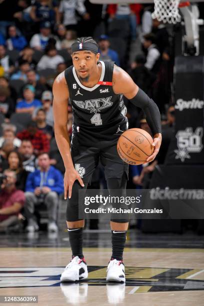 Devonte' Graham of the San Antonio Spurs dribbles the ball against the Dallas Mavericks on March 15, 2023 at the AT&T Center in San Antonio, Texas....