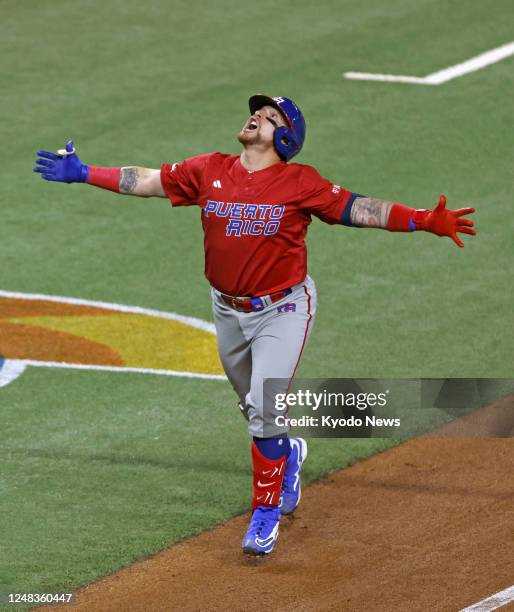 Puerto Rico's Christian Vazquez celebrates on his way to home plate after opening the scoring with a solo homer during the third inning of a World...