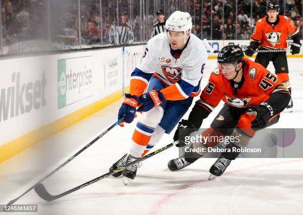 Ryan Pulock of the New York Islanders and Colton White of the Anaheim Ducks battle for position during the second period at Honda Center on March 15,...