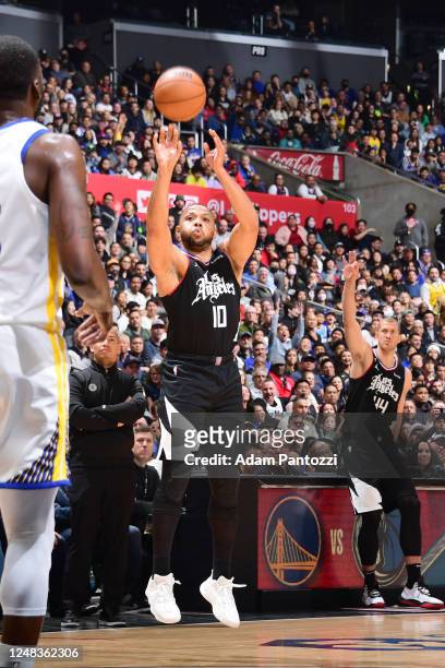 Eric Gordon of the LA Clippers shoots a three point basket during the game against the Golden State Warriors on March 15, 2023 at Crypto.Com Arena in...
