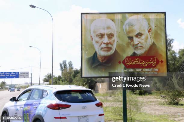 Photo taken on March 10 in Baghdad shows a portrait of Iranian commander Qassem Soleimani and the Iraqi militia Popular Mobilization Forces' leader...