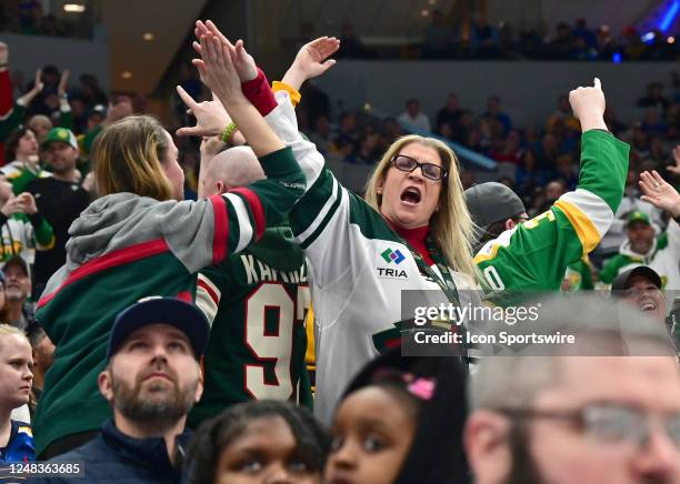 Minnesota fans celebrate in the stands after a goal during a NHL game between the Minnesota Wild and the St. Louis Blues on March 15 at Enterprise...