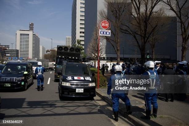 Police officers are seen blocking a car and truck of ultranationalist group on March 16 in Tokyo, Japan, who claim the sovereignty of Japan over the...