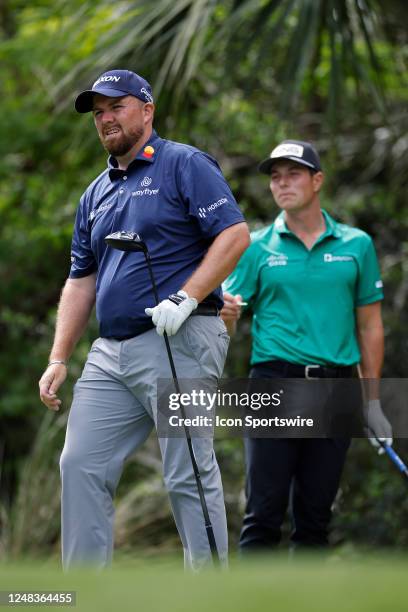 Shane Lowry of Ireland looks up after hitting his drive at the 5th hole as Viktor Hovland of Norway walks to the tee during the first round of THE...
