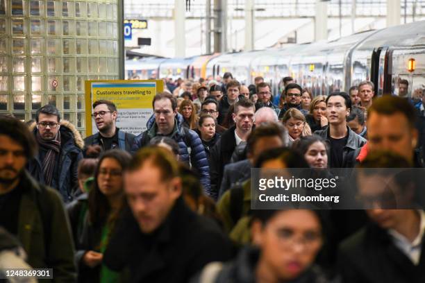 Commuters walk along a platform, during a rail workers strike, at London Waterloo railway station in London, UK, on Thursday, March 16, 2023....