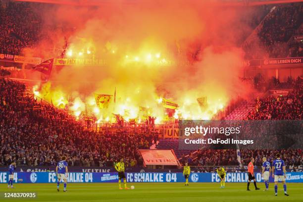 Borussia Dortmund fans release flares inside the stadium release flares during the Bundesliga match between FC Schalke 04 and Borussia Dortmund at...