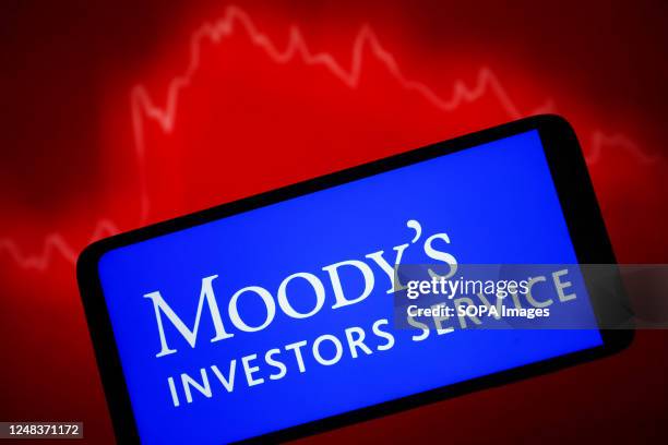 In this photo illustration, Moody's Investors Service logo is seen on a smartphone screen.