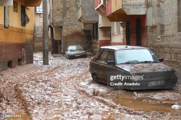 Vehicles are stucked as cleaning operation is ongoing after a large number of vehicles and houses are damaged in the flood disaster in Sanliurfa,...
