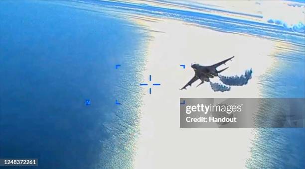 In this screengrab of a video clip released by the United States Defense Department's European Command, a Russian Su-27 fighter jet flies near an...