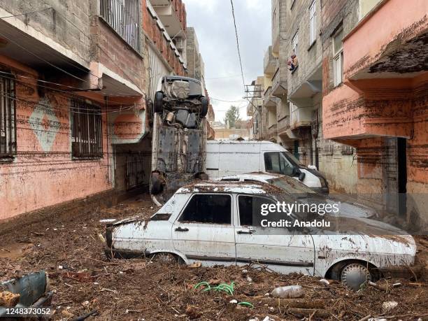 Damaged vehicles are seen around the flooded Karakoyun stream as cleaning works continue after flood hit Sanliurfa, Turkiye on March 16, 2023.