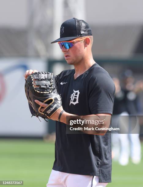 Spencer Torkelson of the Detroit Tigers looks at his Wilson A2000 baseball glove prior to the Spring Training game against the St. Louis Cardinals at...