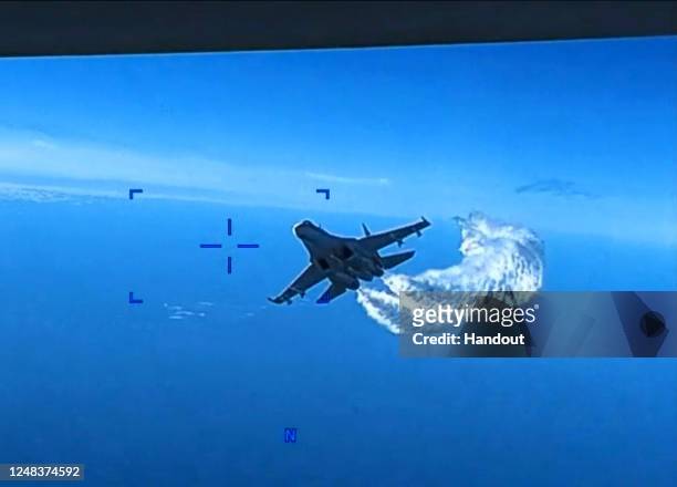 In this screengrab of a video clip released by the United States Defense Department's European Command, a Russian Su-27 fighter jet flies near an...