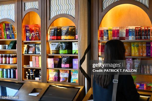 Customer browses a shelf of edible cannabis products displayed for sale at the Green Goddess Collective legal cannabis dispensary on February 15,...