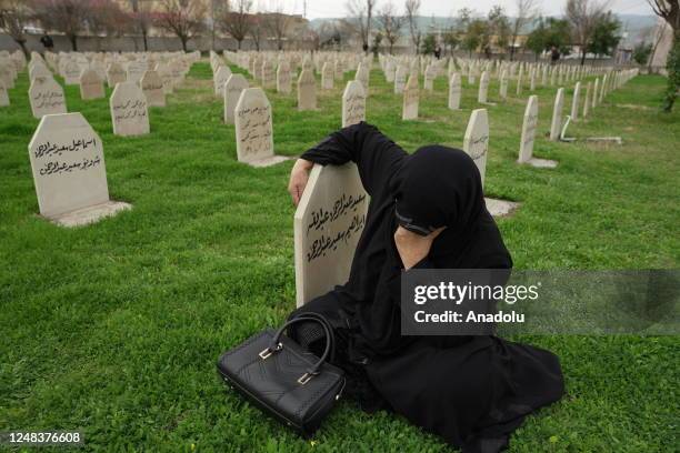 Woman is seen as people visit the Halabja cemetery and Halabja Monument and Peace Museum on the 35th anniversary of Halabja chemical attack in...