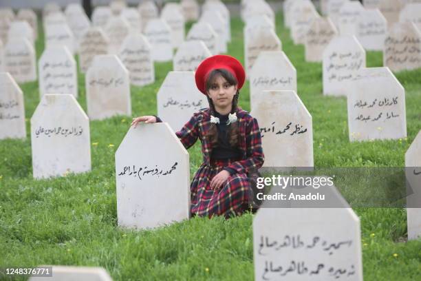 Girl is seen at the Halabja cemetery as people visit the Halabja Monument and Peace Museum on the 35th anniversary of Halabja chemical attack in...