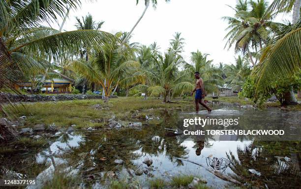 Water welling from the rocky ground forms a new lake in the centre of Amatuku Islet as king tides hit Funafuti Atoll, 20 February 2004, home to...