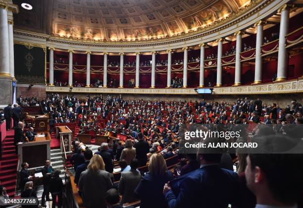 General view shows members of Parliament shouting and singing the national anthem prior to the speech of France's Prime Minister confirmed to force...