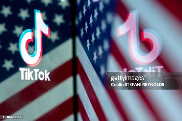 This photo illustration shows the TikTok logo reflected in an image of the US flag, in Washington, DC, on March 16, 2023. - China urged the United...